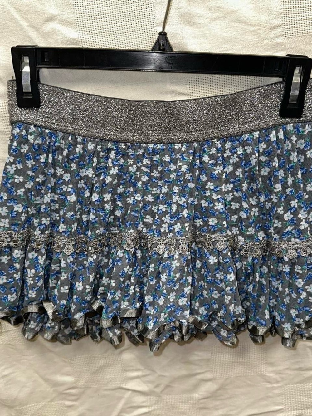 Blue and grey floral ruffle mini skirt with lace trim.